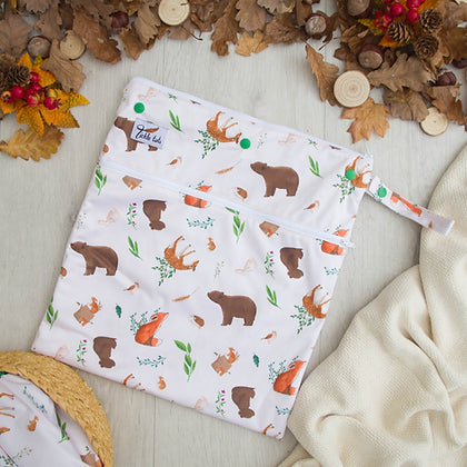 Wet bag with double zip and handle and featuring a woodland pattern.