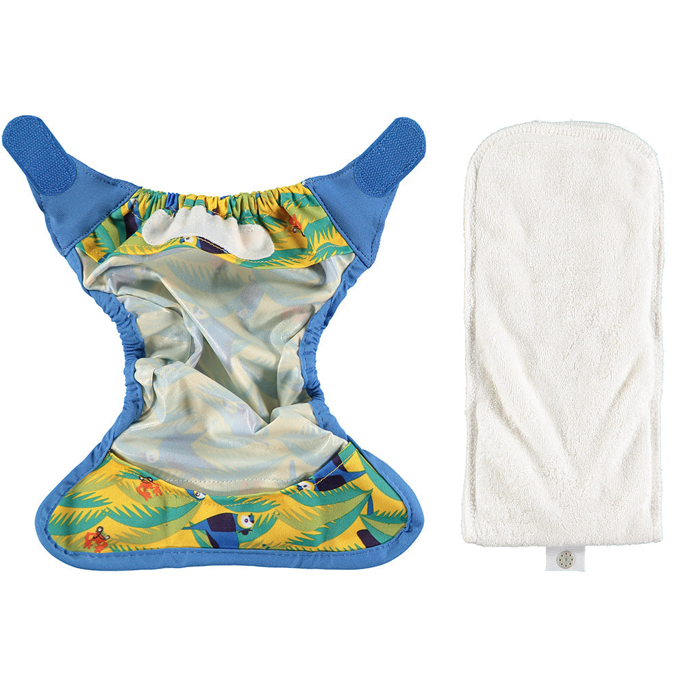 Example of the inside of the newborn reusable cloth nappy with booster to the side and the shell of the nappy opened. 