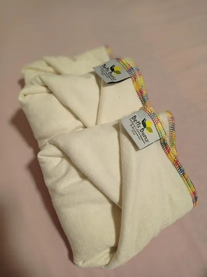 Image of three flat nappies folded and positioned on top of each other. 
