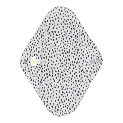 Reusable Sanitary Pad with a white background and a black spotty design on it.