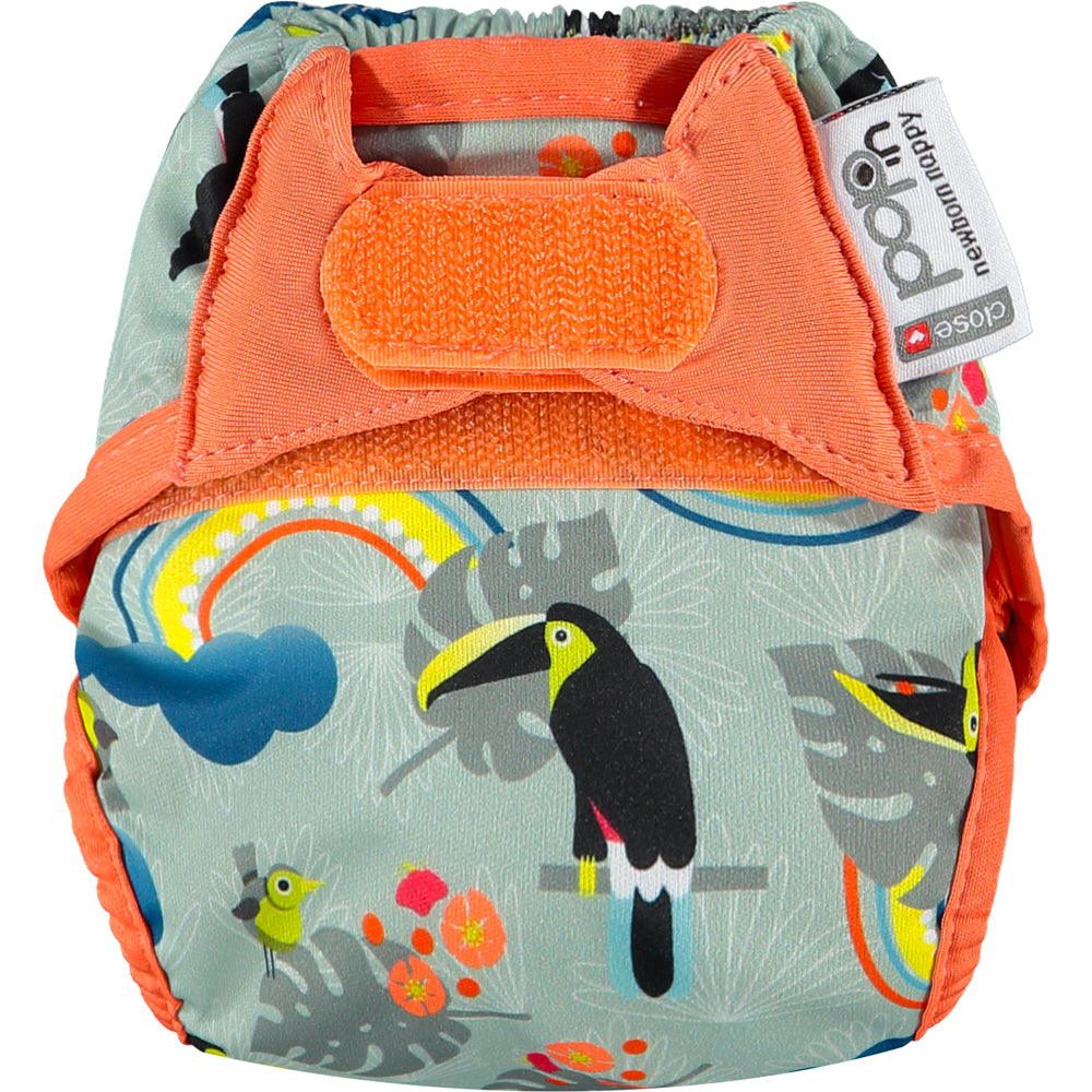 Newborn reusable cloth nappy with velcro fastening and toucan pattern.
