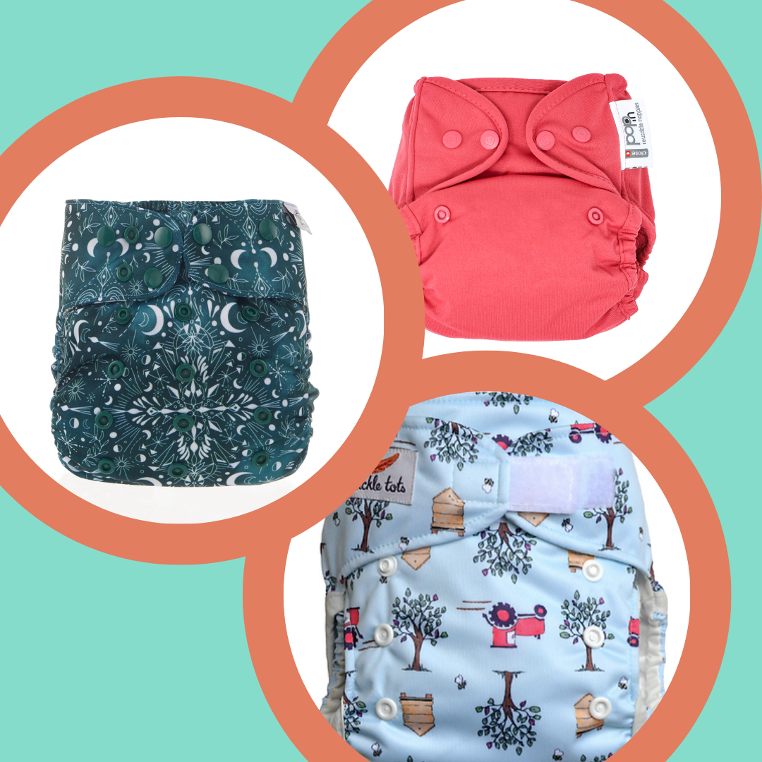 Image of three reusable cloth nappies. Currently one is red, one has a moon print on a dark green background and one is light blue with a tractor print. Images are for illustration only. 