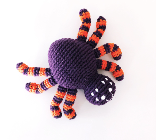 Image of hand crocheted purple spider toy.
