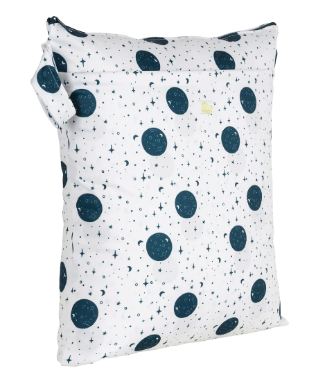 Medium wet bag with white background and dark blue moon and stars print. 